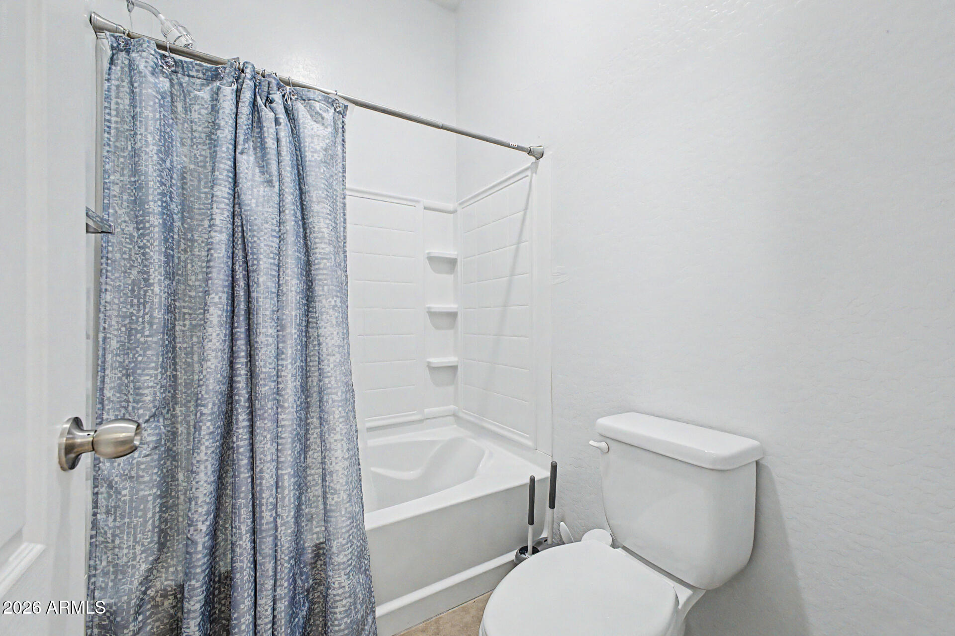 2725 East Mine Creek Road, Unit 1187 Phoenix, AZ 85024 - Photo 18 of 37 a white toilet sitting next to a bath tub