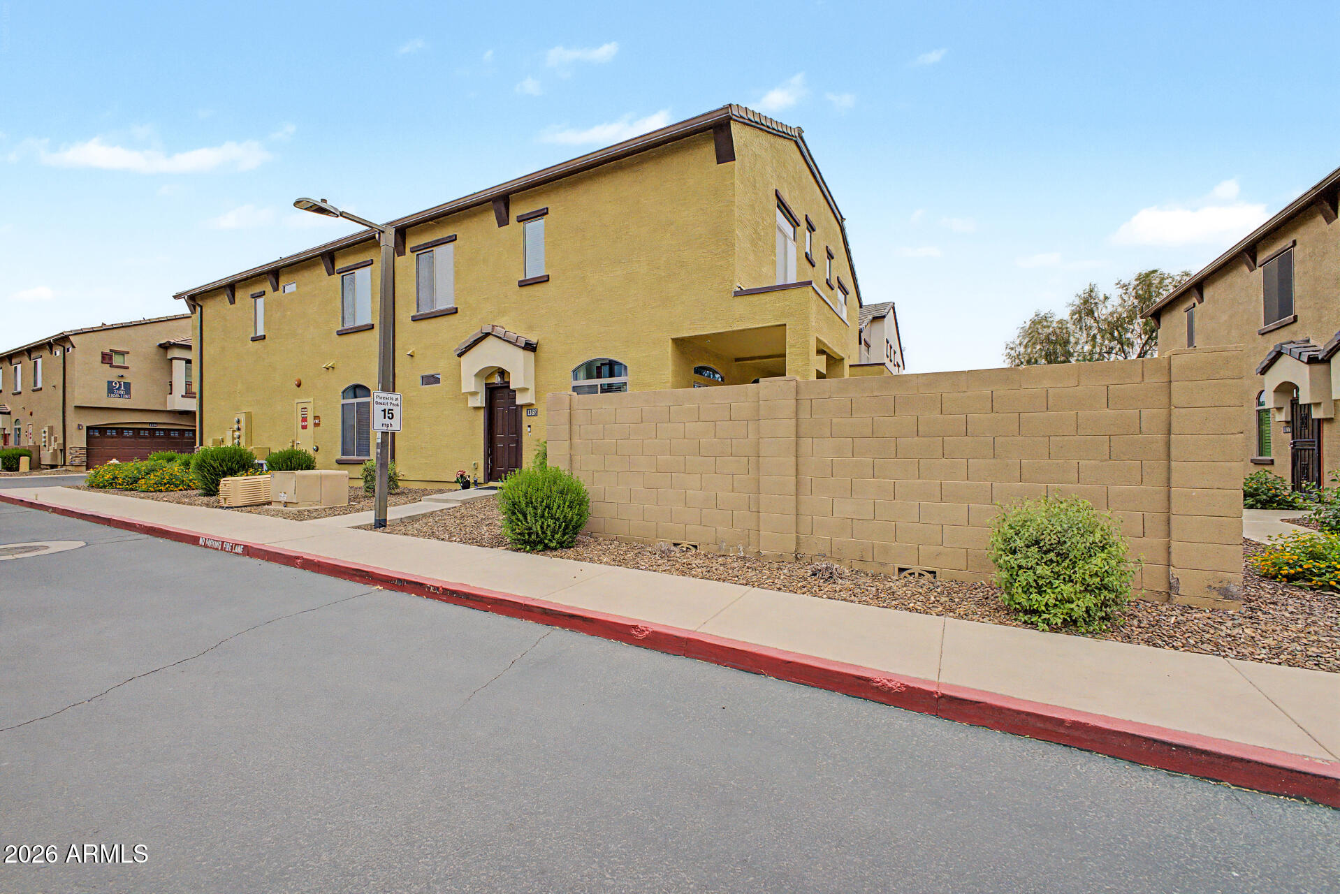 2725 East Mine Creek Road, Unit 1187 Phoenix, AZ 85024 - Photo 3 of 37 a front view of a house with a garden and plants