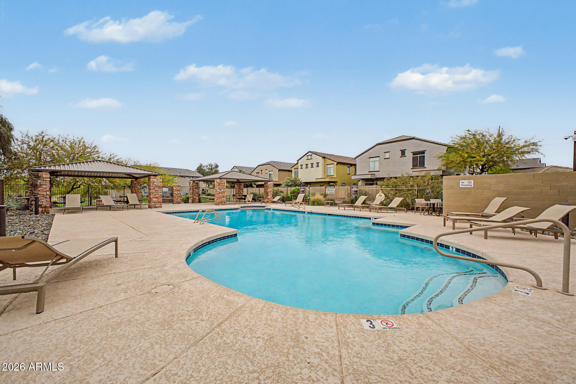 2725 East Mine Creek Road, Unit 1187 Phoenix, AZ 85024 - Photo 31 of 37 a view of a swimming pool with a lounge chair