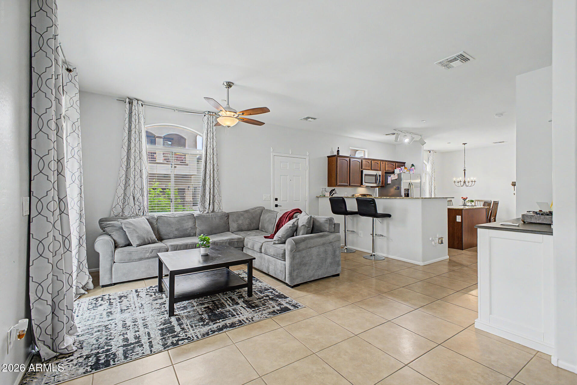 2725 East Mine Creek Road, Unit 1187 Phoenix, AZ 85024 - Photo 4 of 37 a living room with furniture and a view of kitchen