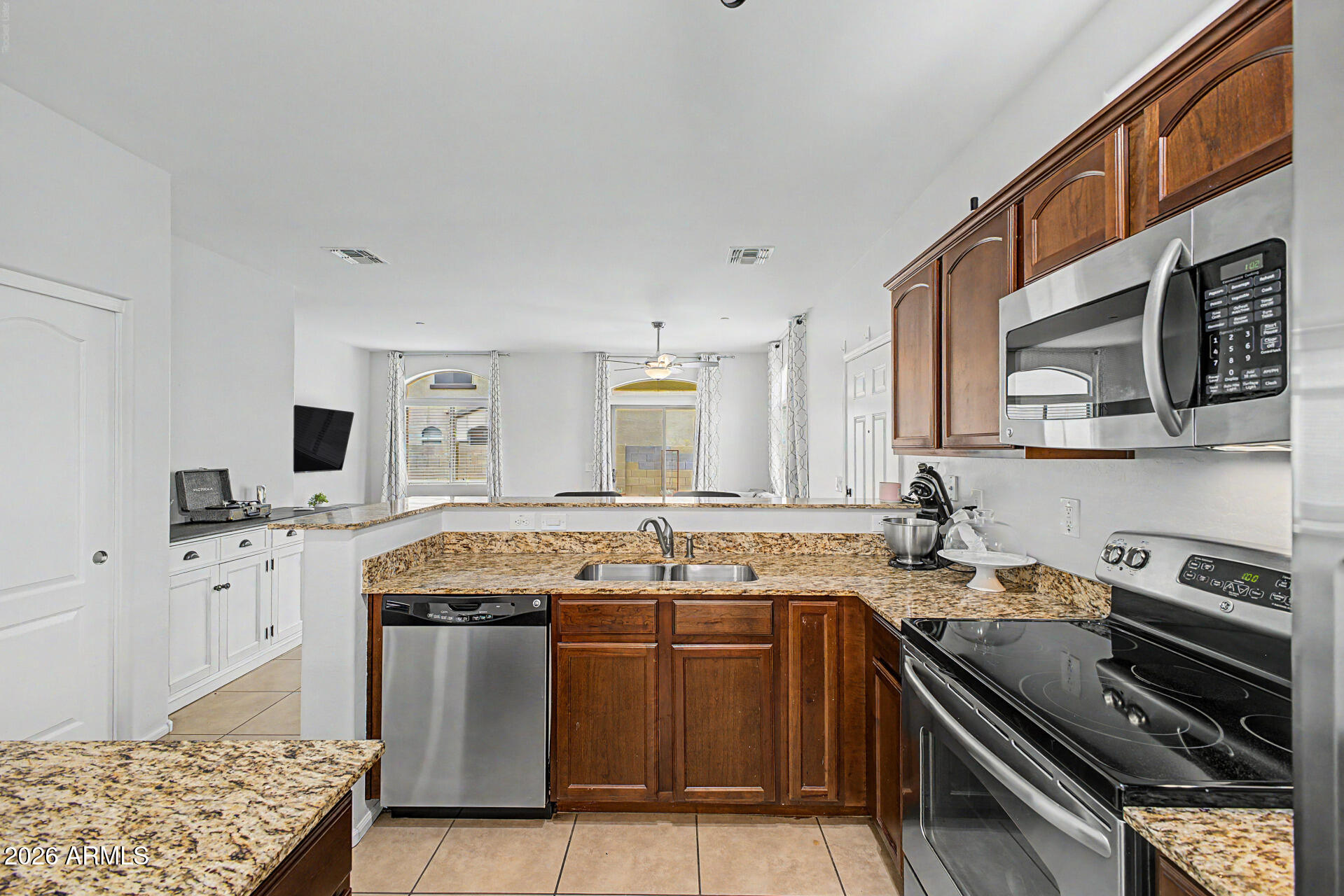 2725 East Mine Creek Road, Unit 1187 Phoenix, AZ 85024 - Photo 8 of 37 a kitchen with stainless steel appliances granite countertop a stove sink and cabinets