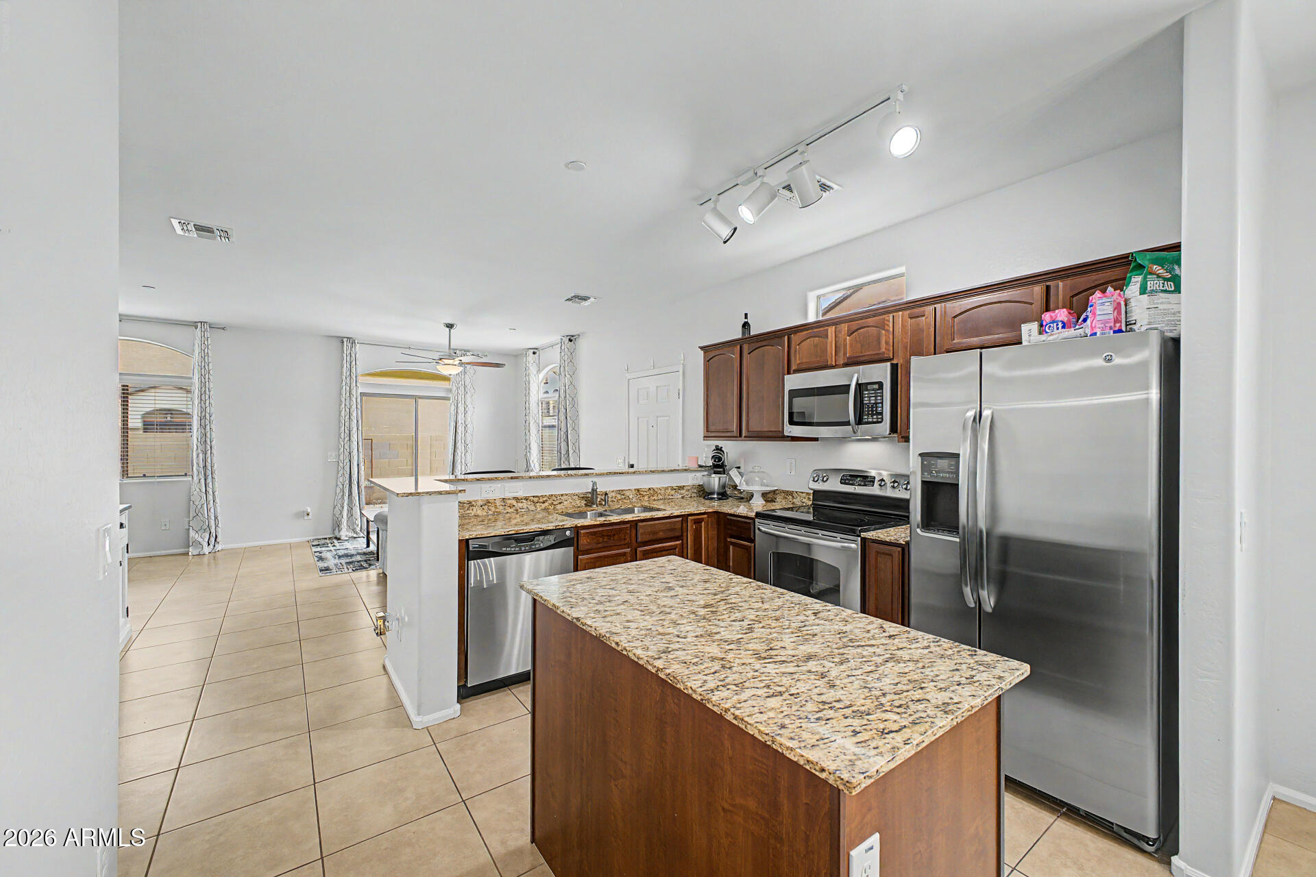 2725 East Mine Creek Road, Unit 1187 Phoenix, AZ 85024 - Photo 9 of 37 a kitchen with stainless steel appliances granite countertop a refrigerator and a stove