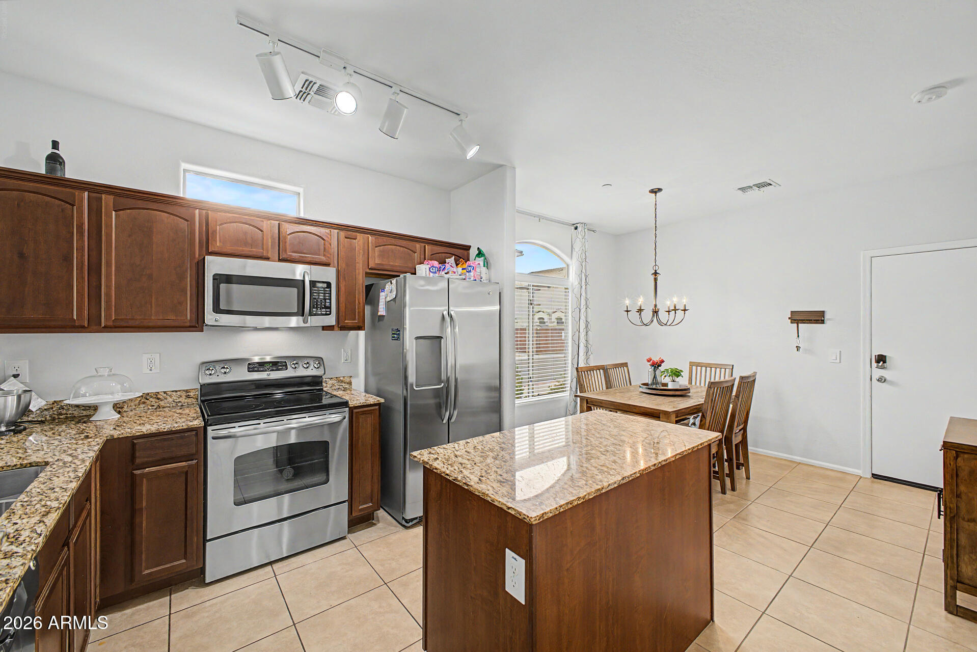 2725 East Mine Creek Road, Unit 1187 Phoenix, AZ 85024 - Photo 10 of 37 a kitchen with stainless steel appliances granite countertop a sink stove and refrigerator