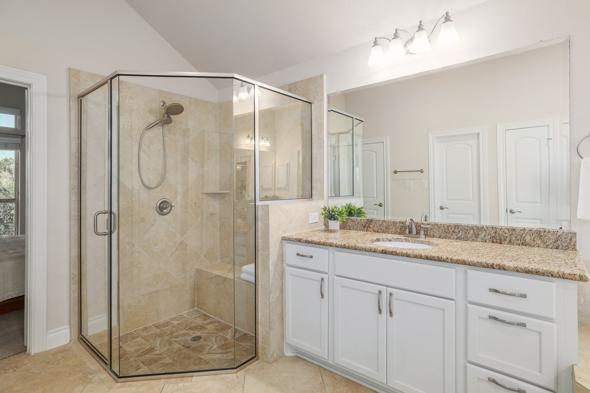 173 Santa Maria Street Georgetown, TX 78628 - Photo 24 of 39 Shower enclosure with glass panels, a built-in bench, and a hand-held showerhead