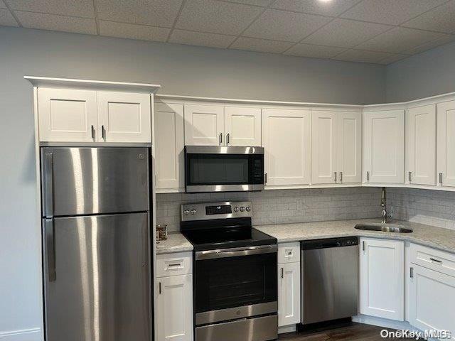 a kitchen with a refrigerator stove and microwave