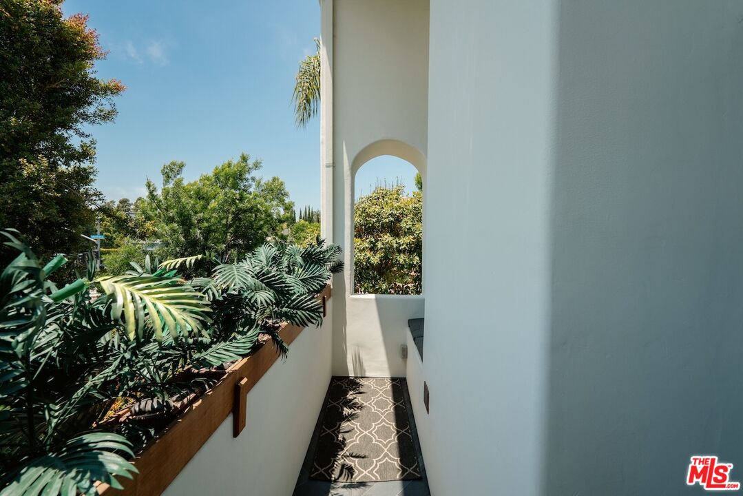2612 Montana Avenue, Unit 1 Santa Monica, CA 90403 - Photo 11 of 27 a balcony with couple of flower plants and wooden fence