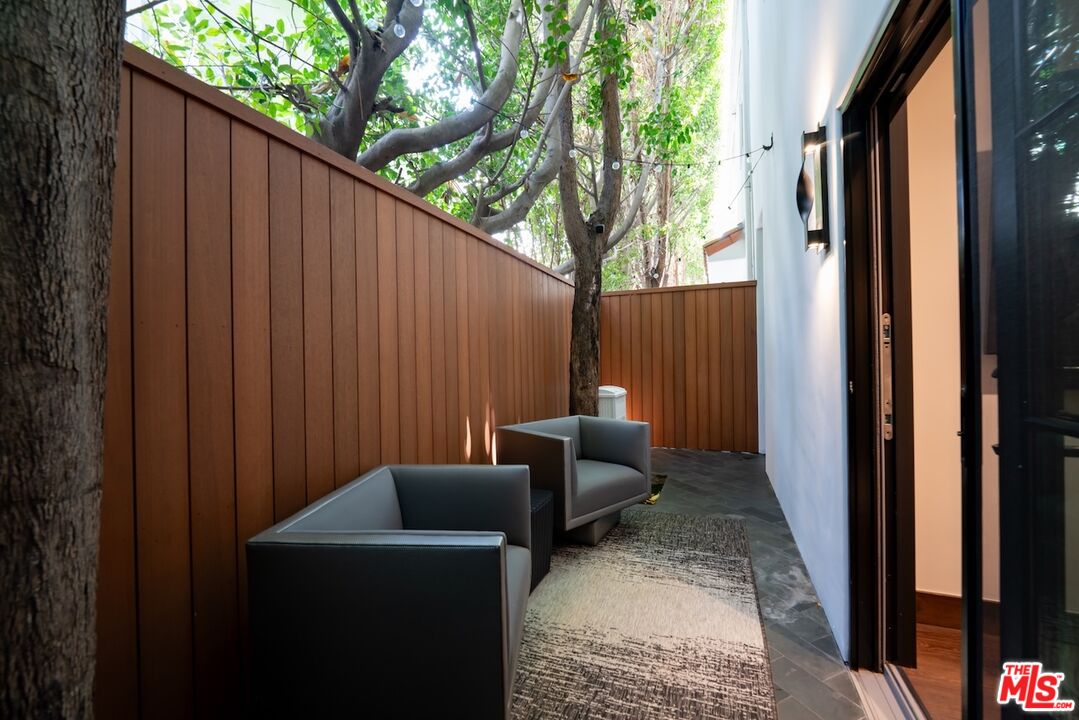 2612 Montana Avenue, Unit 1 Santa Monica, CA 90403 - Photo 18 of 27 a backyard of a house with couches plants and wooden fence