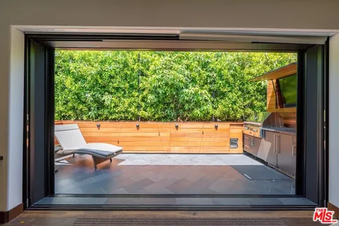 a view of a floor to ceiling window and a yard