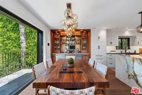 a view of a dining room with furniture wooden floor and chandelier