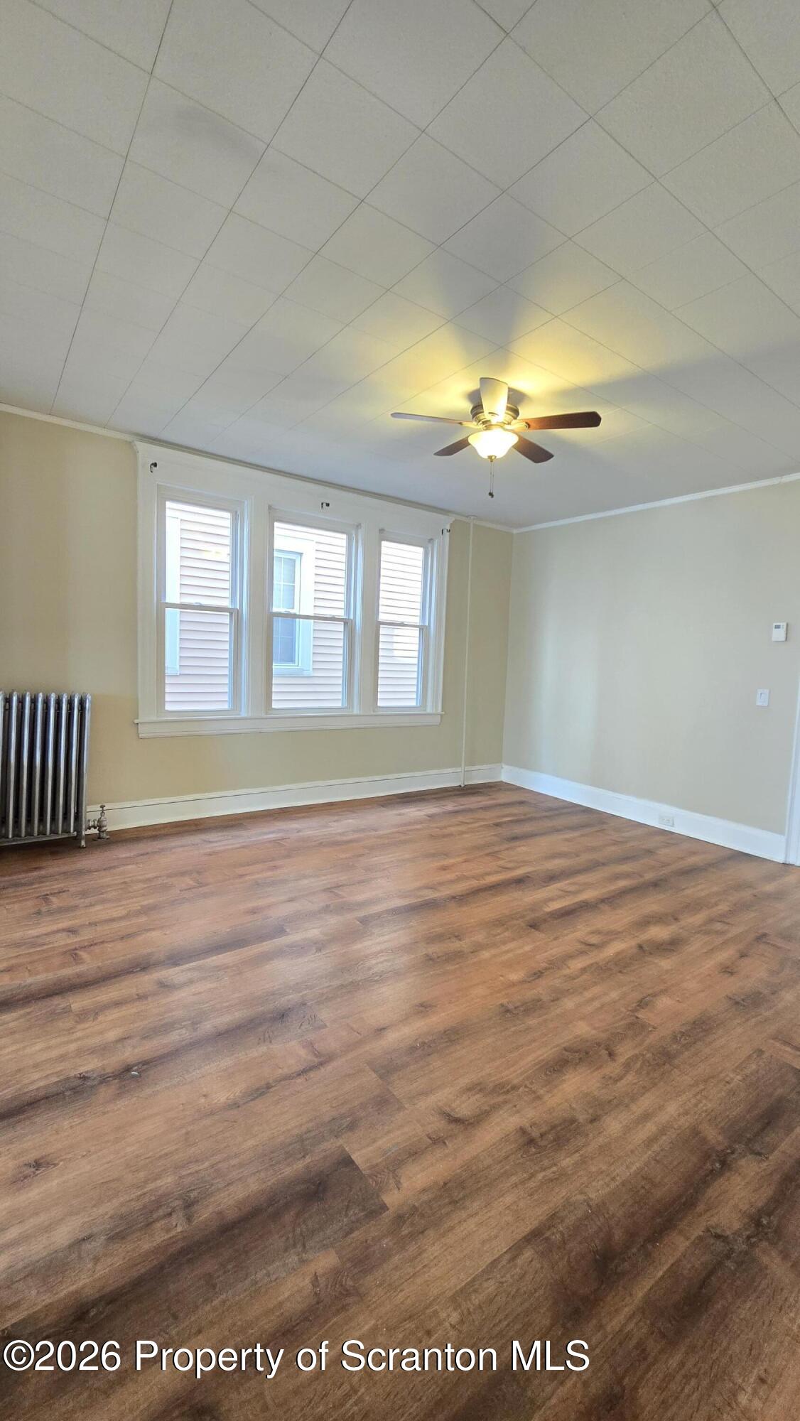 543 North Sumner Avenue Scranton, PA 18504 - Photo 5 of 16 an empty room with wooden floor and windows