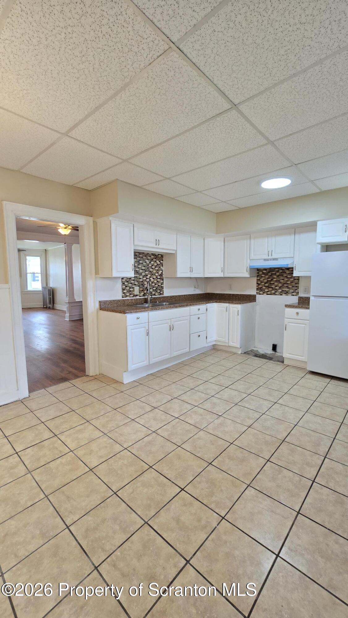 543 North Sumner Avenue Scranton, PA 18504 - Photo 6 of 16 a large kitchen with a stove a refrigerator a sink dishwasher with a dining table and chairs