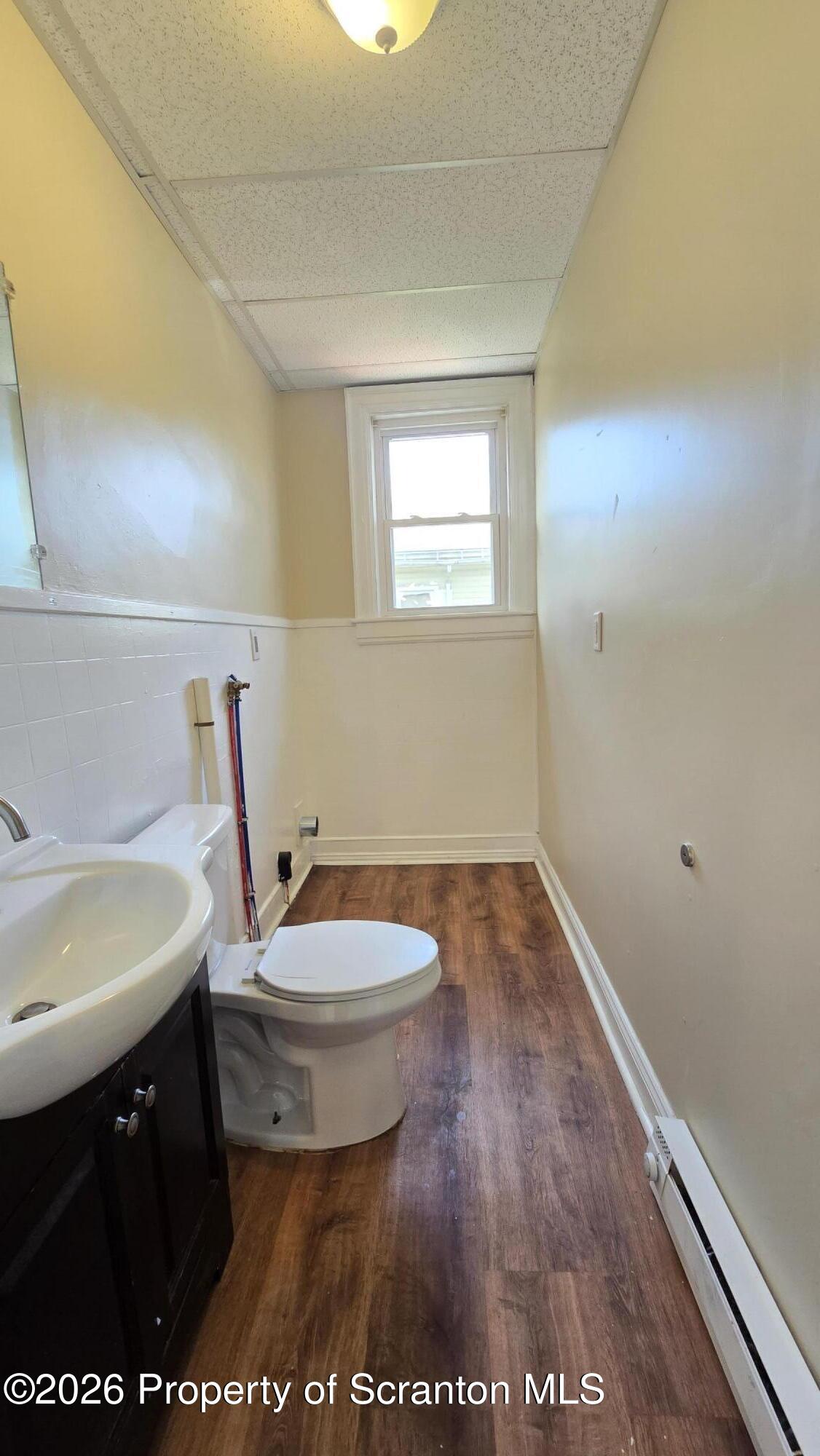 543 North Sumner Avenue Scranton, PA 18504 - Photo 8 of 16 a bathroom with a sink a toilet and a vanity