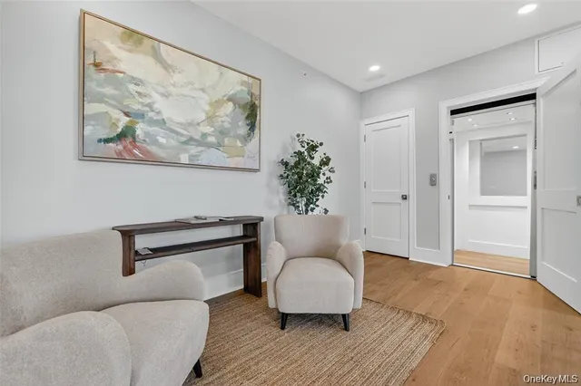 a living room with furniture and a painting on the wall