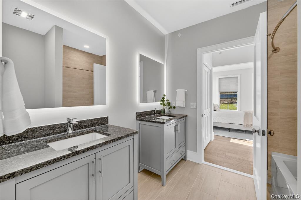 1828 Soundview Court Yorktown Heights, NY 10598 - Photo 29 of 39 a bathroom with a granite countertop sink and a mirror