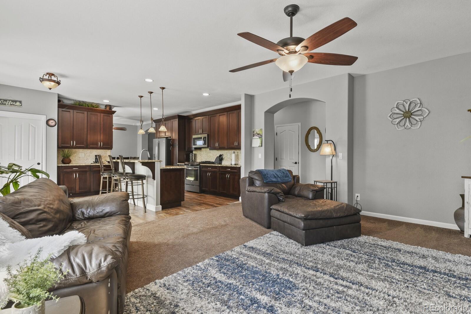 21018 Saddleback Circle Parker, CO 80138 - Photo 18 of 50 a living room with furniture kitchen view and a chandelier