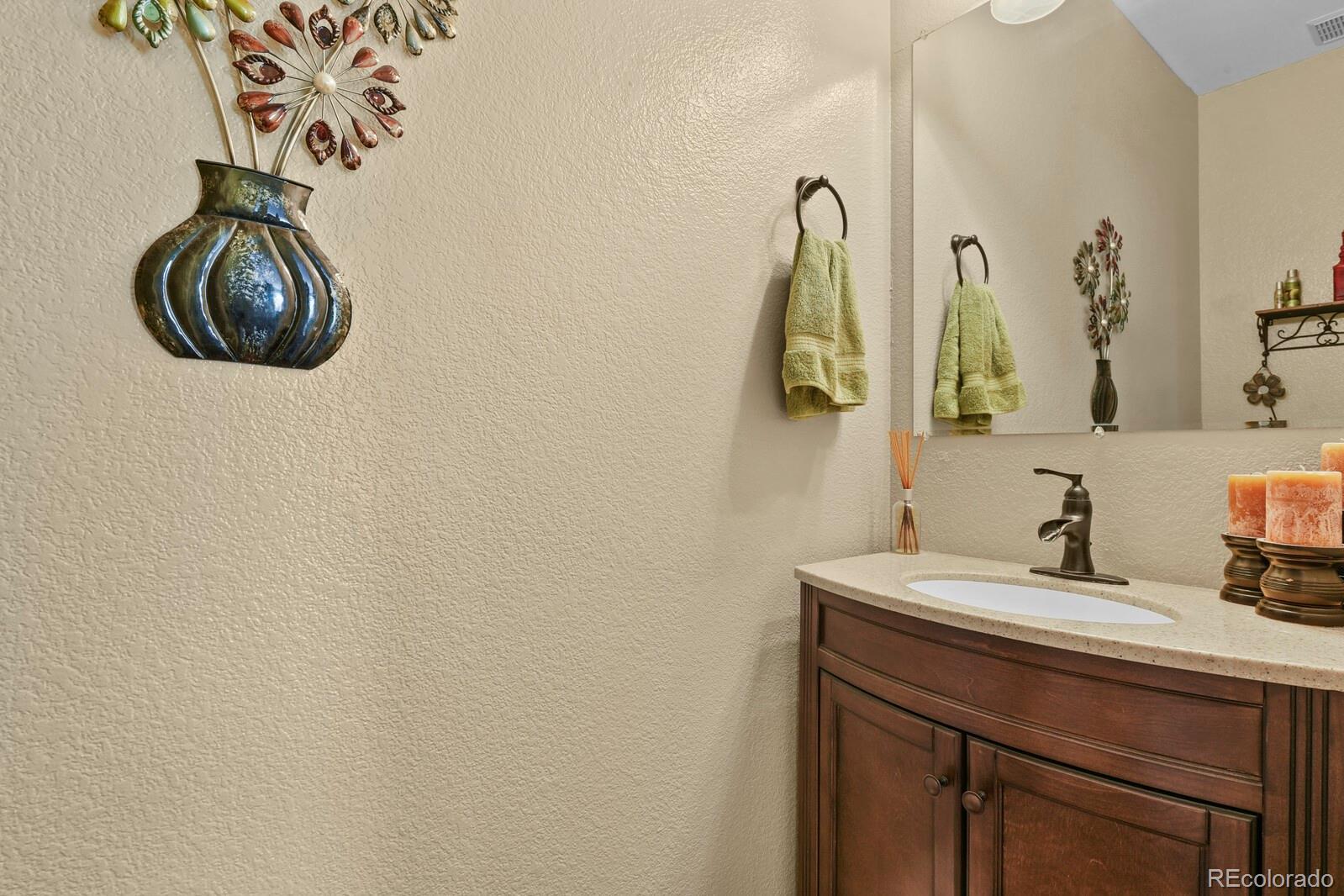 21018 Saddleback Circle Parker, CO 80138 - Photo 21 of 50 a bathroom with a sink and a mirror