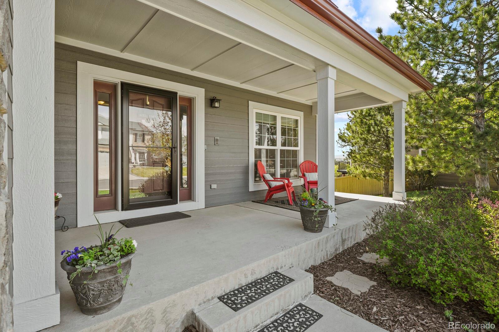 21018 Saddleback Circle Parker, CO 80138 - Photo 3 of 50 a man sitting on a bench in front of a house