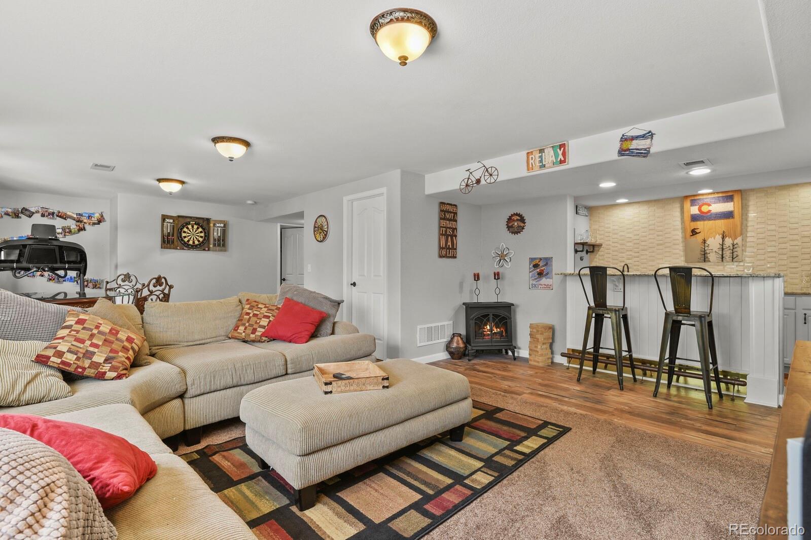 21018 Saddleback Circle Parker, CO 80138 - Photo 34 of 50 a living room with furniture and a fireplace