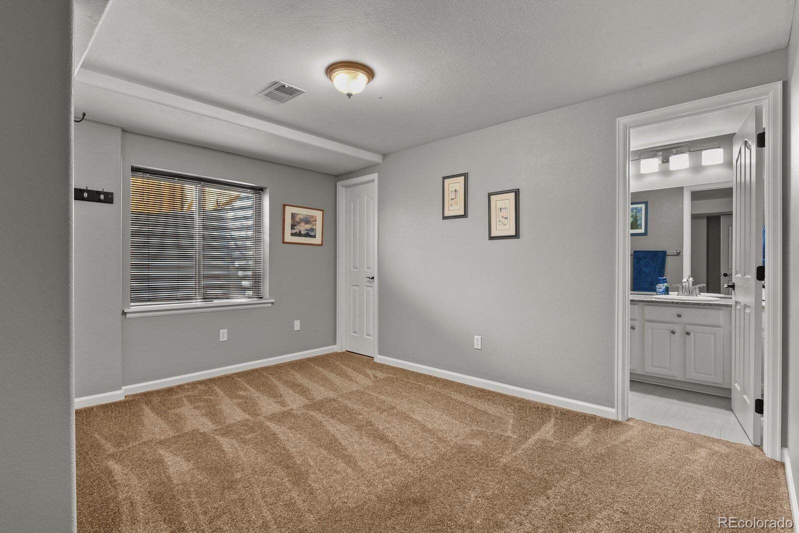 21018 Saddleback Circle Parker, CO 80138 - Photo 37 of 50 a view of an empty room with window and cabinet