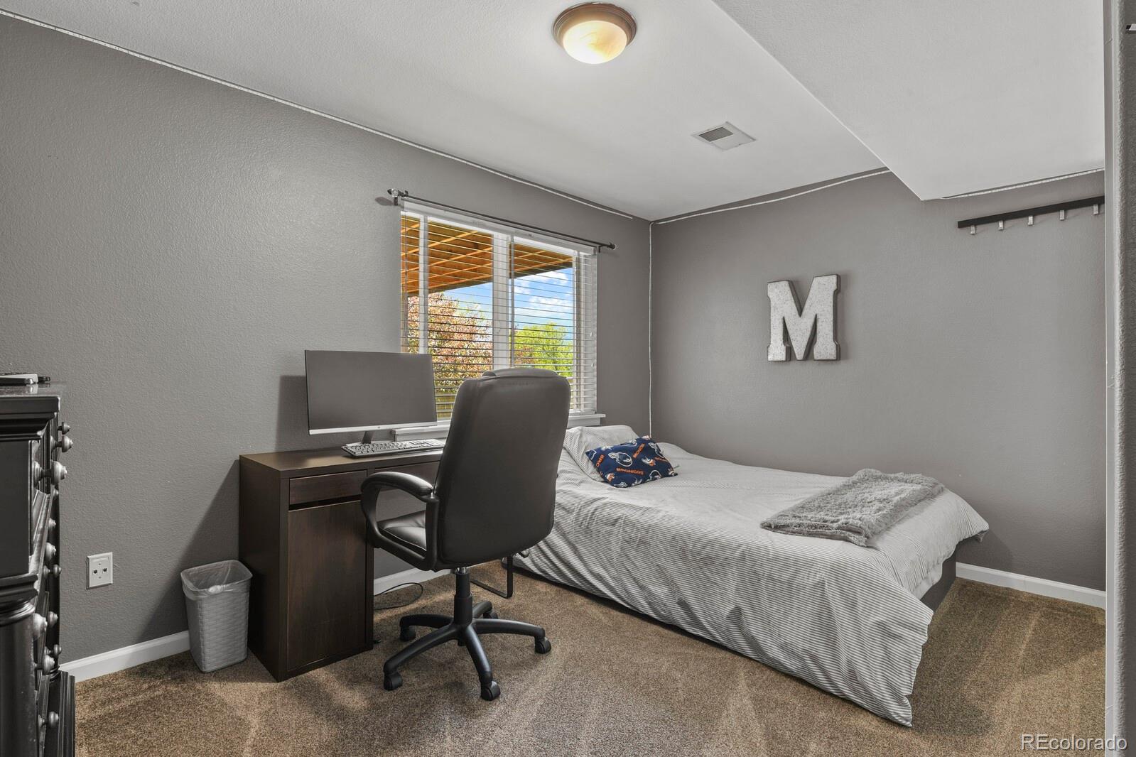 21018 Saddleback Circle Parker, CO 80138 - Photo 39 of 50 a bedroom with a workspace