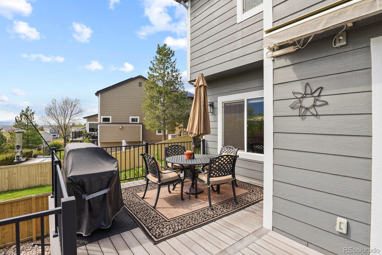21018 Saddleback Circle Parker, CO 80138 - Photo 42 of 50 a patio with table and chairs and potted plants