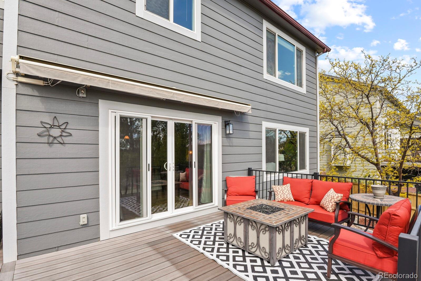 21018 Saddleback Circle Parker, CO 80138 - Photo 43 of 50 a view of a patio with a table and chairs and wooden floor