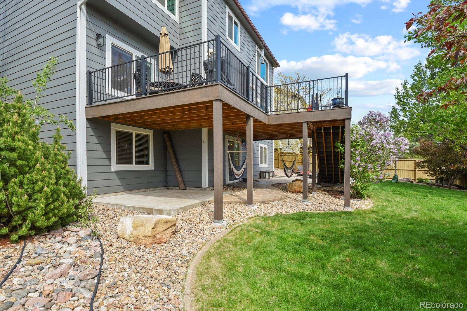 21018 Saddleback Circle Parker, CO 80138 - Photo 47 of 50 a view of a house with backyard porch and sitting area