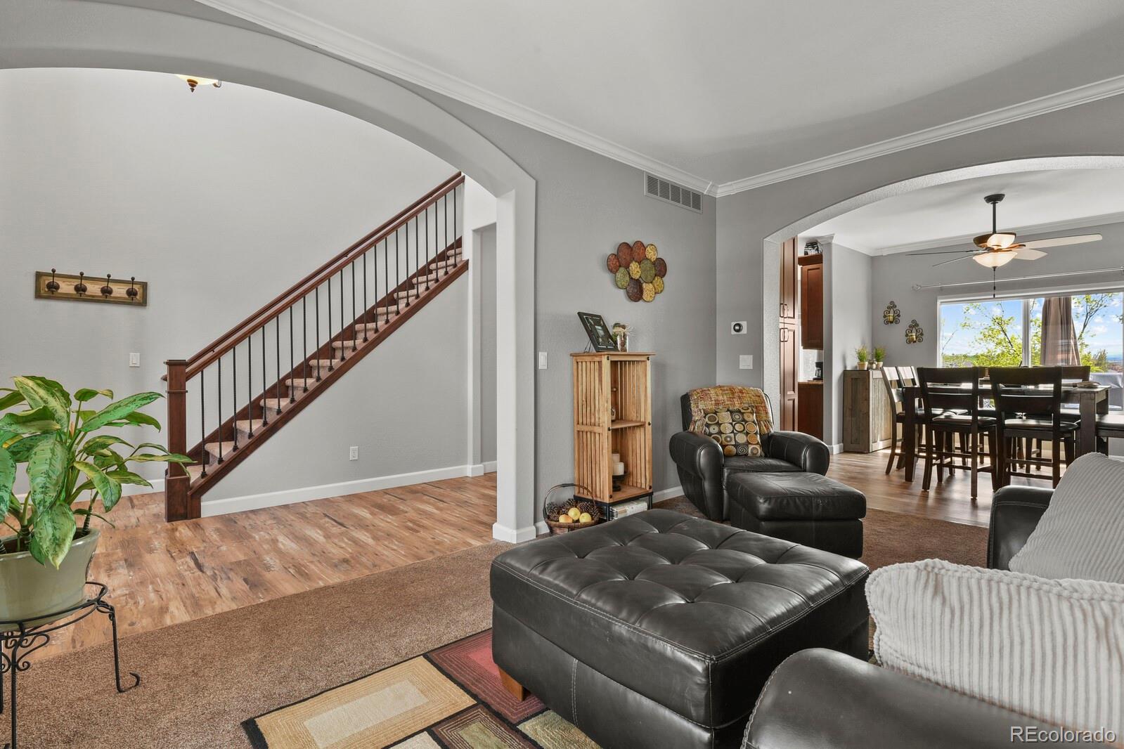 21018 Saddleback Circle Parker, CO 80138 - Photo 6 of 50 a living room with furniture and wooden floor