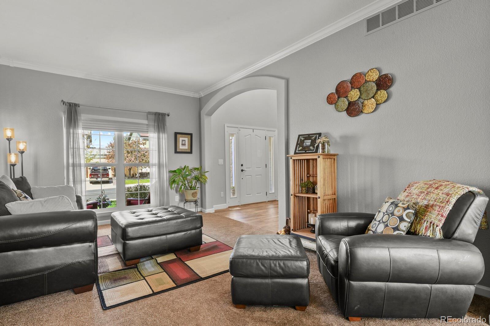 21018 Saddleback Circle Parker, CO 80138 - Photo 7 of 50 a living room with furniture and a large window