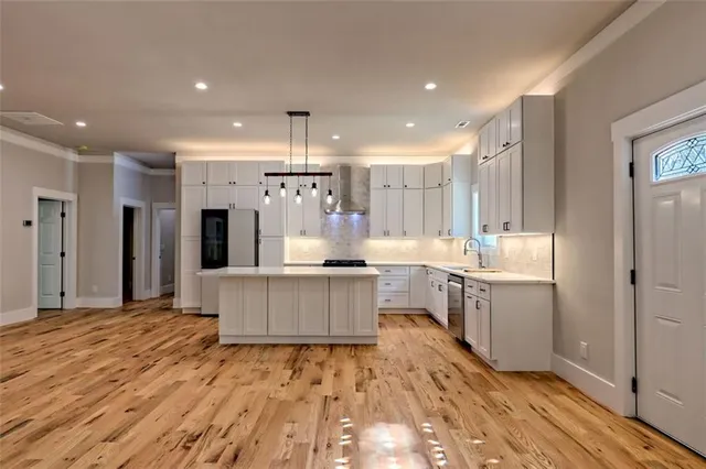 a view of a hallway with wooden floor and entryway