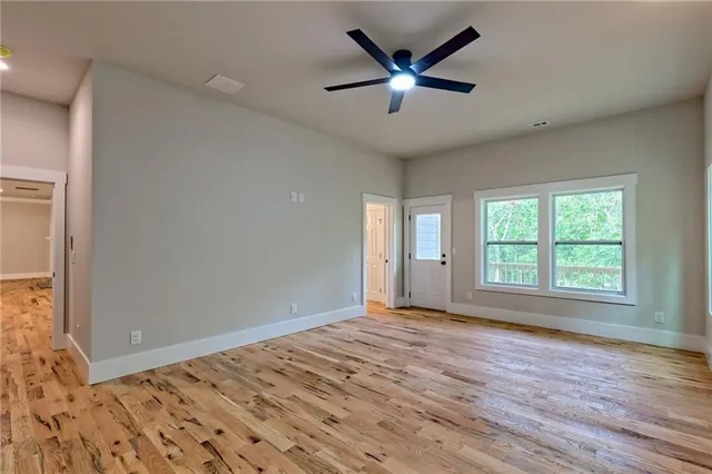 a view of a room with wooden floor and a window