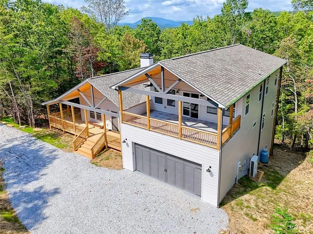 a front view of a house with a yard garage and outdoor seating