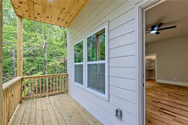 a view of a house with a yard and wooden fence