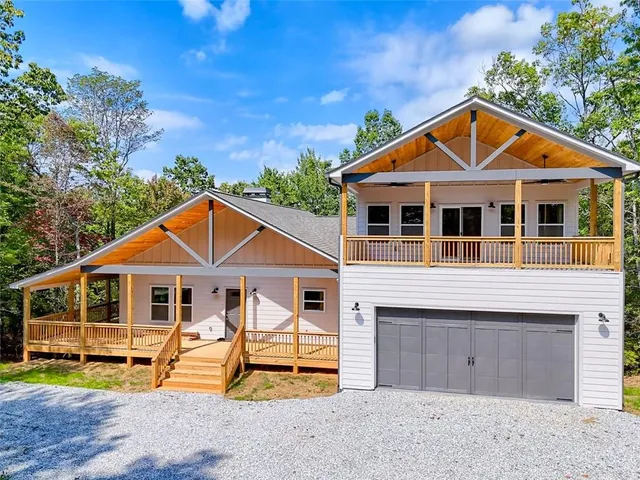 a kitchen with kitchen island granite countertop a refrigerator oven a sink and white cabinets