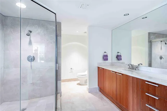 a bathroom with a double vanity sink mirror and toilet