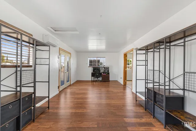 a view of a livingroom with wooden floor and furniture