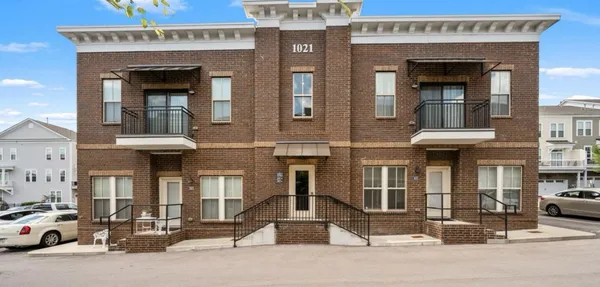 a front view of a building with parking