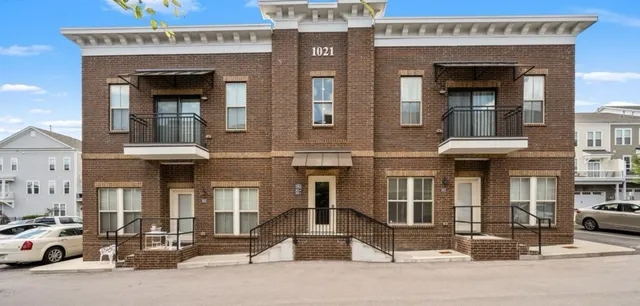 a front view of a building with parking