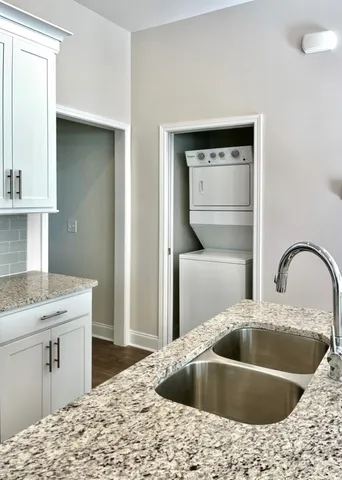 a kitchen with stainless steel appliances a stove top oven a sink dishwasher and a refrigerator