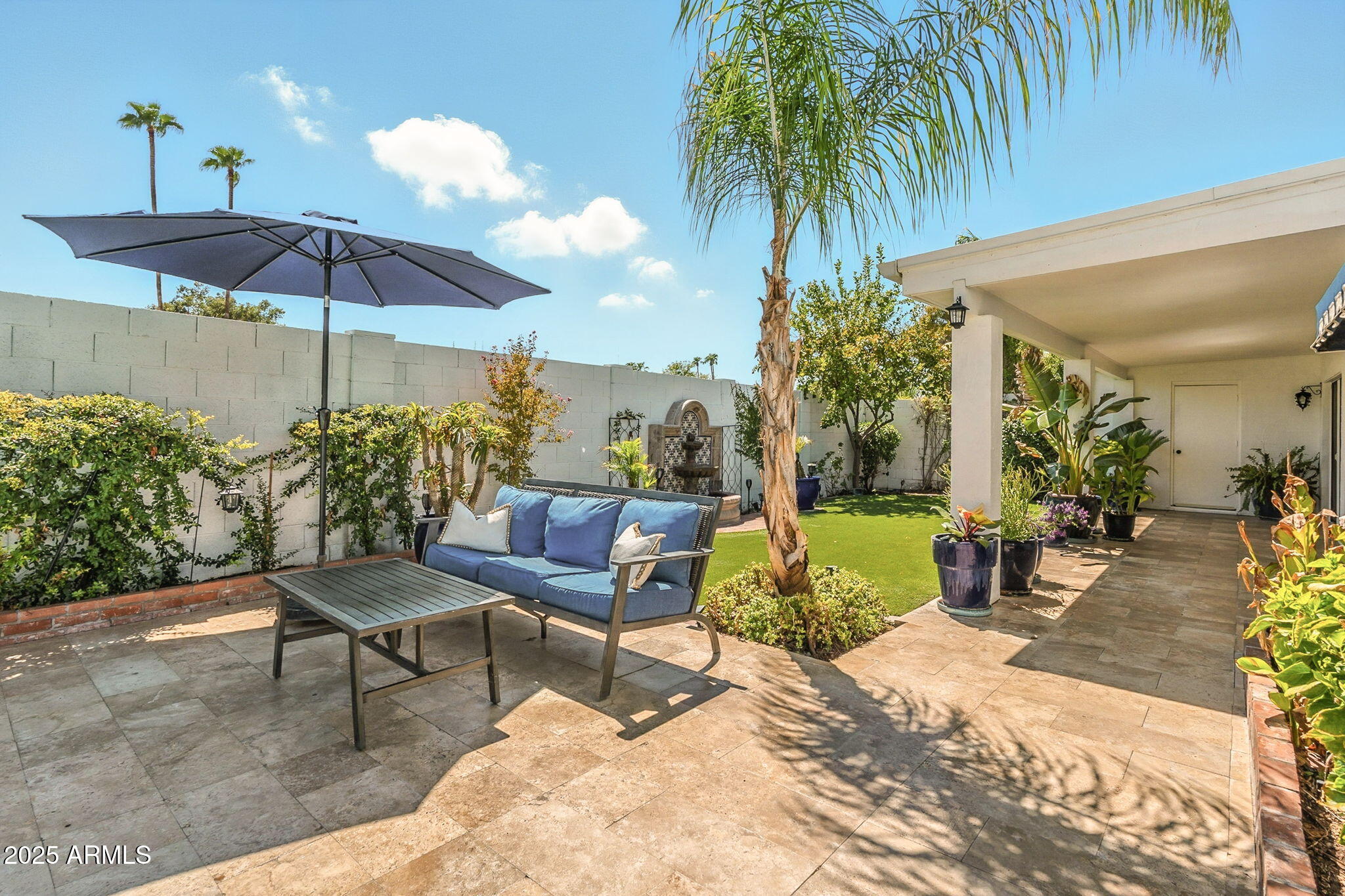 43 East Boca Raton Road Phoenix, AZ 85022 - Photo 81 of 99 a view of a backyard with a patio table and chairs under an umbrella