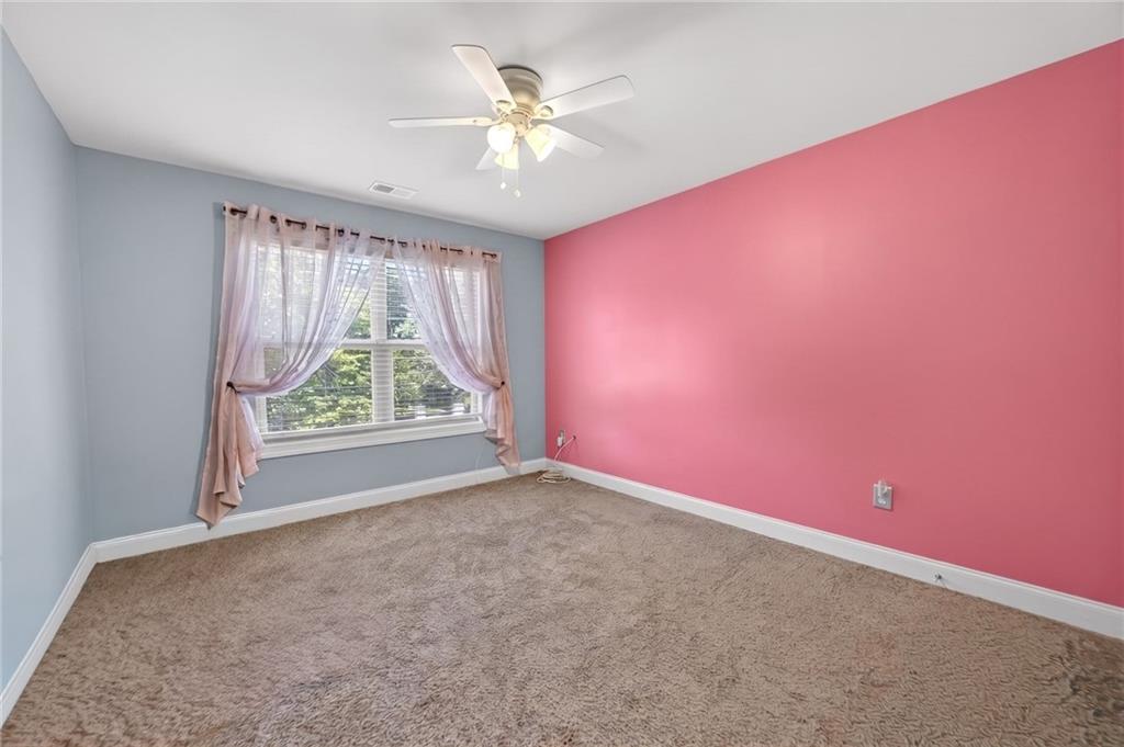2300 Tucker Mill Road Southwest Conyers, GA 30094 - Photo 31 of 45 an empty room with windows and fan