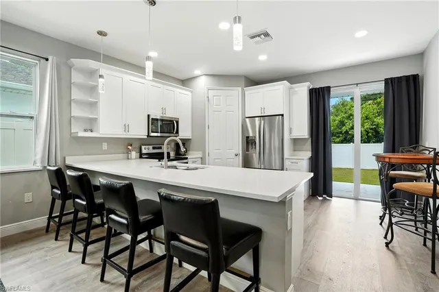 a kitchen with a sink appliances and cabinets