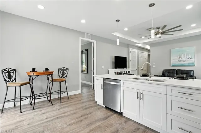 a kitchen with kitchen island a dining table and chairs