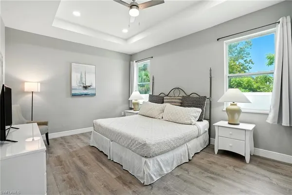 a large white kitchen with a view of living room