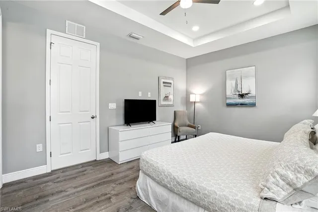 a bedroom with a bed wooden floor and window