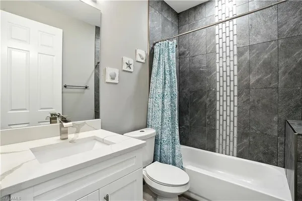 a bedroom with a bed and a ceiling fan