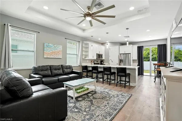 a living room with furniture kitchen view and a table