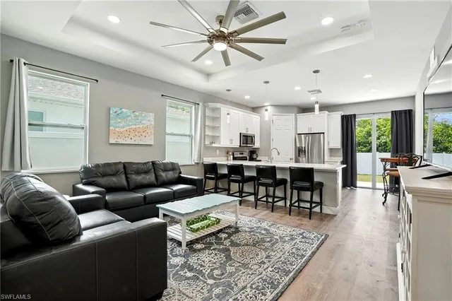 a living room with furniture kitchen view and a table