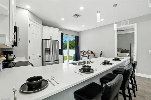 a kitchen with a table chairs stove and refrigerator