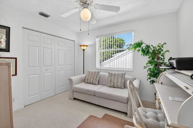 an aerial view of residential houses with outdoor space and trees all around